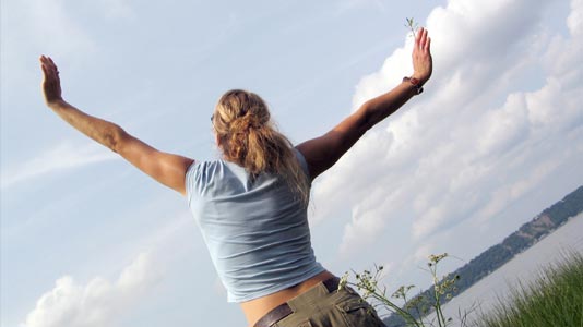 Woman stretching outside in the countryside