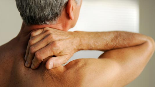 Man feeling his shoulder with pain